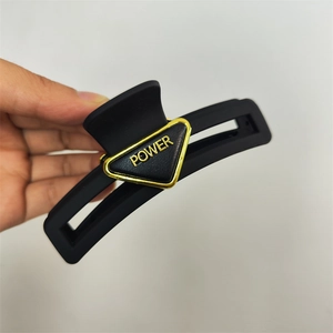 Matte black triangle hair claw clip with golden POWER metallic logo for women