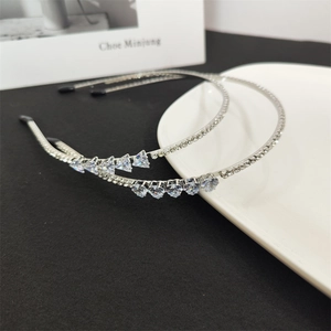 Detail of silver alloy headbands with triangle and heart-shaped sparkling crystals