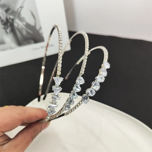 Detailed macro view of three silver rhinestone headbands featuring heart and star crystals