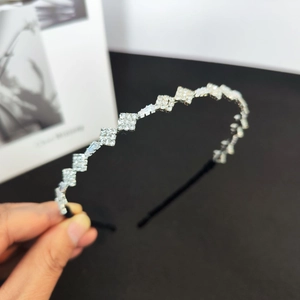 Close-up detail of silver geometric crystal headband with hand-set sparkling square zircons