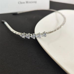 Detailed view of silver rhinestones and triangle crystals on a slim metal headband