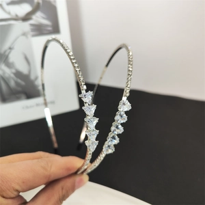 Detail of silver headband with sparkling rhinestones and tiered triangular crystal accents