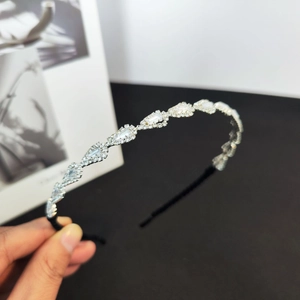 Detail of silver rhinestone headband featuring sparkling crystal leaf leaf-shaped patterns