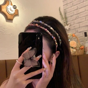 Détail de serre-têtes en cristal rose et violet superposés pour un look chic et élégant