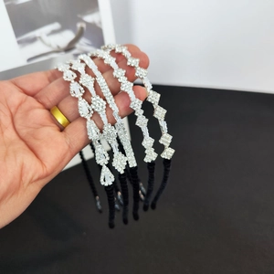 Detailed macro view of silver alloy headbands with sparkling white crystal pavé insets