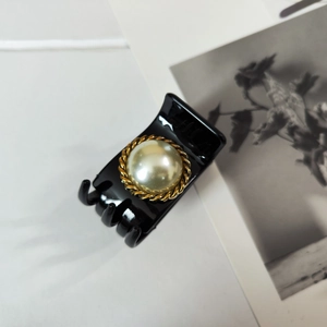 Elegant French vintage black hair claw with a cream pearl and golden twisted metal frame