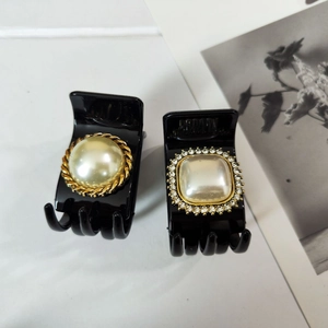 Detail of French vintage hair clips with round and square faux pearls and rhinestones