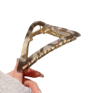 Triangle acetate hair claw clip with brown marble texture and gold metal spring for thick hair