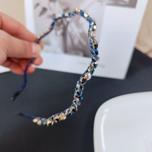 Detail of hand-woven headband featuring navy blue crystals and intricate fishline weaving