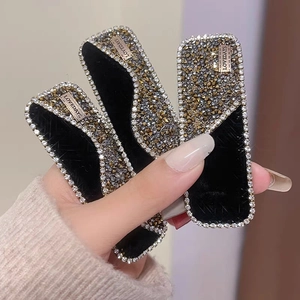 Three-piece black velvet hair clips set with sparkling rhinestones and metal nameplate