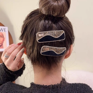 Elegant black velvet hair clips with sparkling gold rhinestones and wave-shaped design