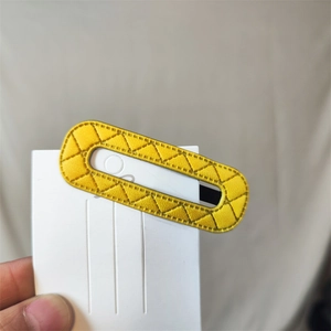 Detail of yellow quilted PU leather BB hair clip with elegant diamond lattice texture