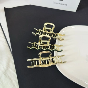 Set of three wave-shaped hollow gold metal hair claws with durable springs and polished finish