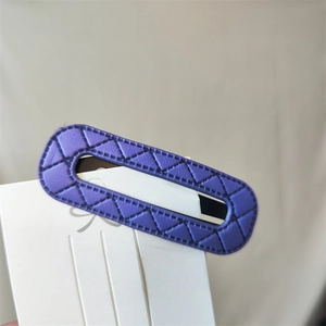 Detail view of purple oval PU leather hair clip with triangular stitching texture