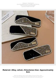 Close-up of black velvet hair clip with champagne rhinestones and alloy label