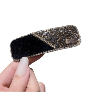 Elegant black velvet hair clip with sparkling rhinestones and Lovedays metal tag