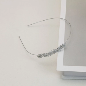 Close-up of minimalist cat eye stone headband with elegant silver leafy wheat patterns