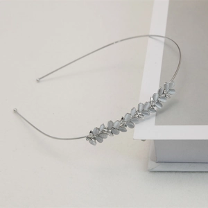 Detail of silver headband with grey cat eye stone leaves and sparkling rhinestones