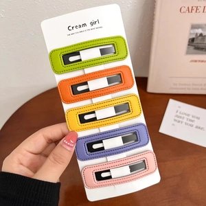 Détail de cinq barrettes colorées en cuir PU avec surpiqûres sur une carte