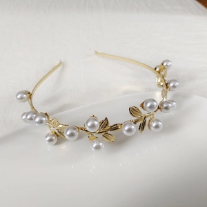 Elegant gold leaf headband with white pearls in a baroque style metal hair accessory