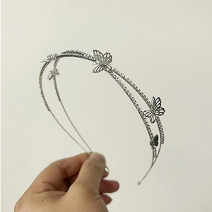 Detail of silver double-layered headband featuring hollow butterfly motifs and sparkling rhinestones