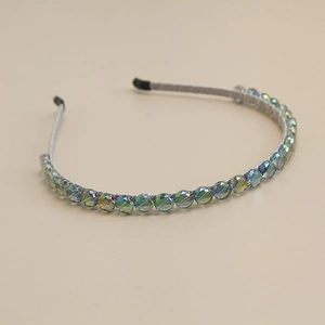 Macro detail of iridescent crystal beads on slim grey fabric headband with soft ear tips