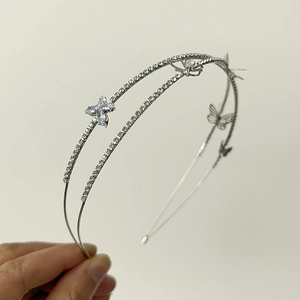 Close-up of silver double-layered headband with hollow butterflies and sparkling rhinestones
