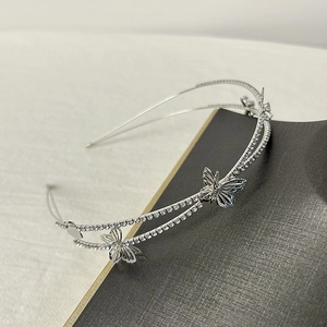 Macro shot of silver hollow butterfly headband with sparkling rhinestones and double metal band