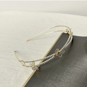 Detail shot of golden double-layer headband with hollow butterfly and sparkling rhinestones