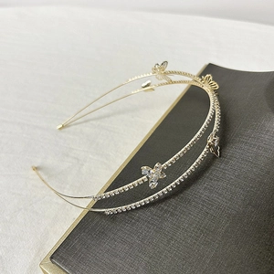 Detail of golden double-layer headband with hollow butterfly rhinestones and metal finish
