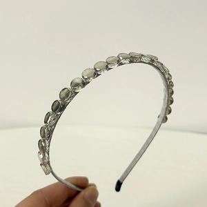 Close-up of elegant crystal headband showing clear faceted glass beads and slim frame