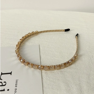 Detailed view of champagne crystal beaded headband with multi-faceted glass stones