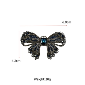 Detailed view showing dimensions of vintage blue crystal bow brooch with faux pearls