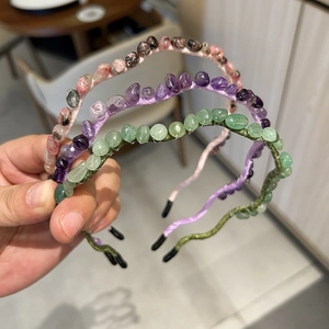 Detail of beaded headbands featuring pink, purple, and green irregular gemstones