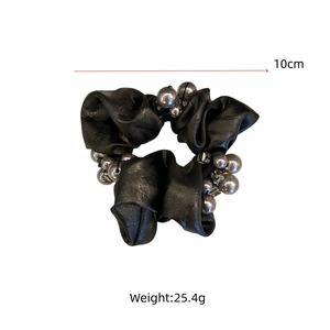 Detail of a black satin hair scrunchie with grey pearls, 10cm diameter and 25.4g weight