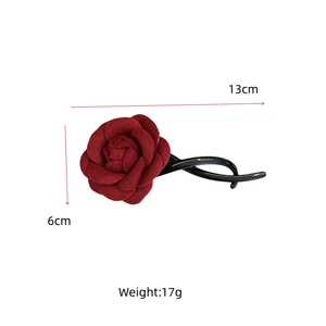 Detail of red fabric rose flower hair claw clip with 13cm black spiral resin fork