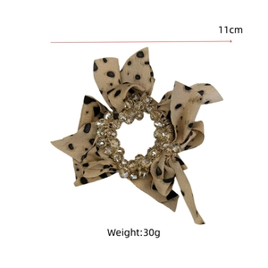Detail view of 11cm leopard print satin scrunchie with crystal beads and 30g weight