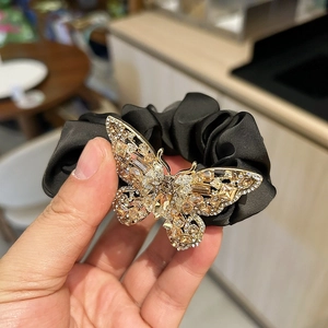 Detailed macro of crystal butterfly hair scrunchie with sparkling champagne rhinestones