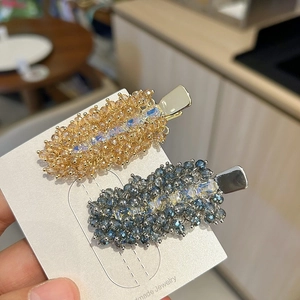 Detailed macro view of handmade beaded crystal hair clips on jewelry display card
