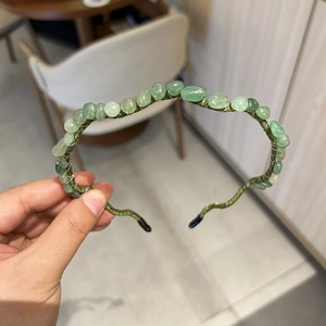Detail of handmade beaded headband with green natural stone chips on slim metal wire