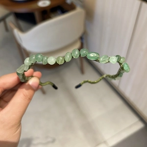 Detail view of handmade green stone beaded headband with irregular natural minerals