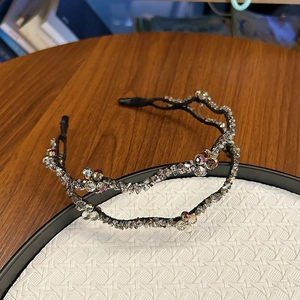 Close-up of double-layer crystal beaded headband with sparkling metal framework detail