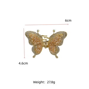 Vue détaillée de la pince à cheveux papillon avec pierres ambre et dimensions