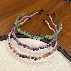 Detail of beaded headbands featuring polished green aventurine and amethyst crystals