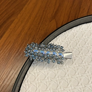 Elegant beaded crystal hair clip featuring blue and grey stones on a premium alloy base