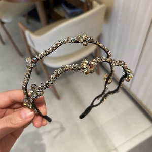 Detail showing two sparkling crystal beaded hairbands with champagne and iridescent stones