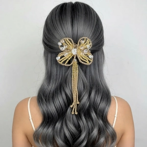 Luxurious butterfly hair clip with crystal tassels and beaded details on wavy hair