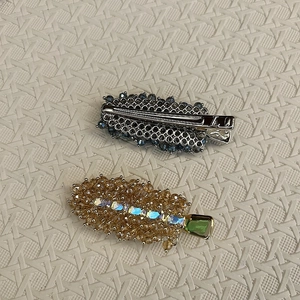Detailed view of handmade crystal beaded hair clips with luxury blue and gold accents