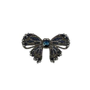 Elegant vintage bow brooch with deep blue crystal and grey gradient pearls