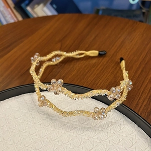 Detail of double-layer wave headband with champagne crystals and woven gold wire
